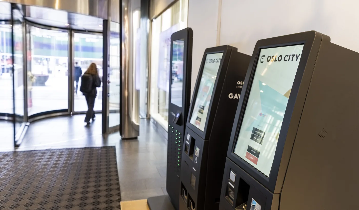 Three Microlog gift card kiosks inside the entrance of Oslo City shopping centre.