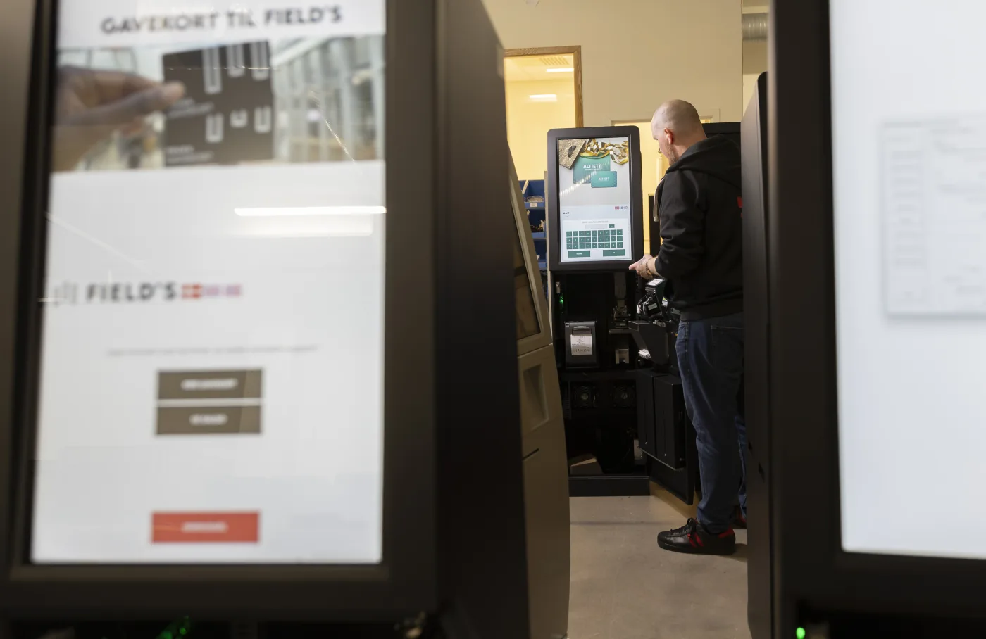 Microlog technician testing a gift card kiosk in the service workshop.