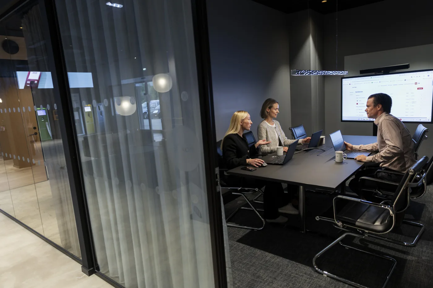 Microlog team reviewing the customer portal together in a meeting room.